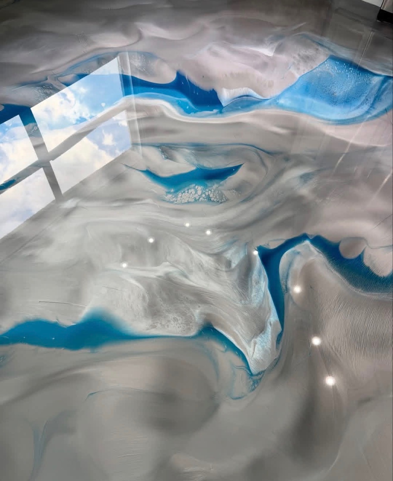 Glossy blue and pearl metallic epoxy floor detail