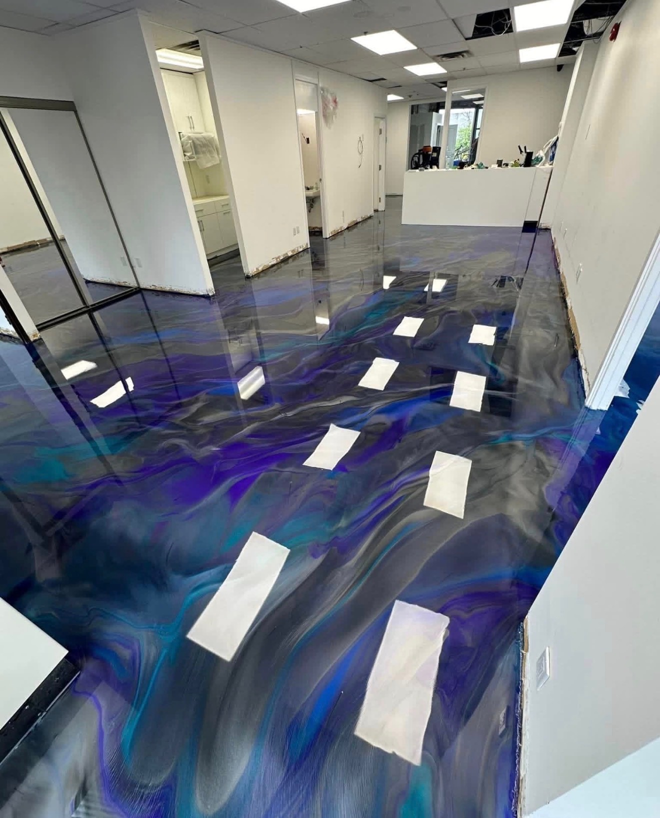 Blue and charcoal metallic epoxy floor in a commercial interior